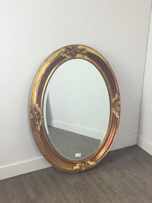 Lot 540 - AN OVAL BEVELLED WALL MIRROR