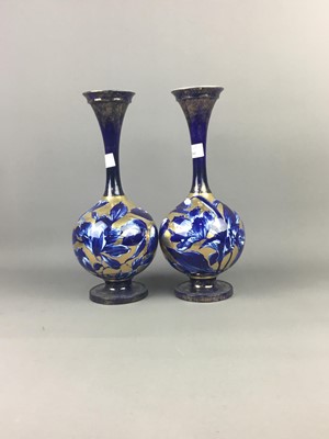 Lot 561 - A PAIR OF LATE VICTORIAN BLUE AND GILT CIRCULAR VASES