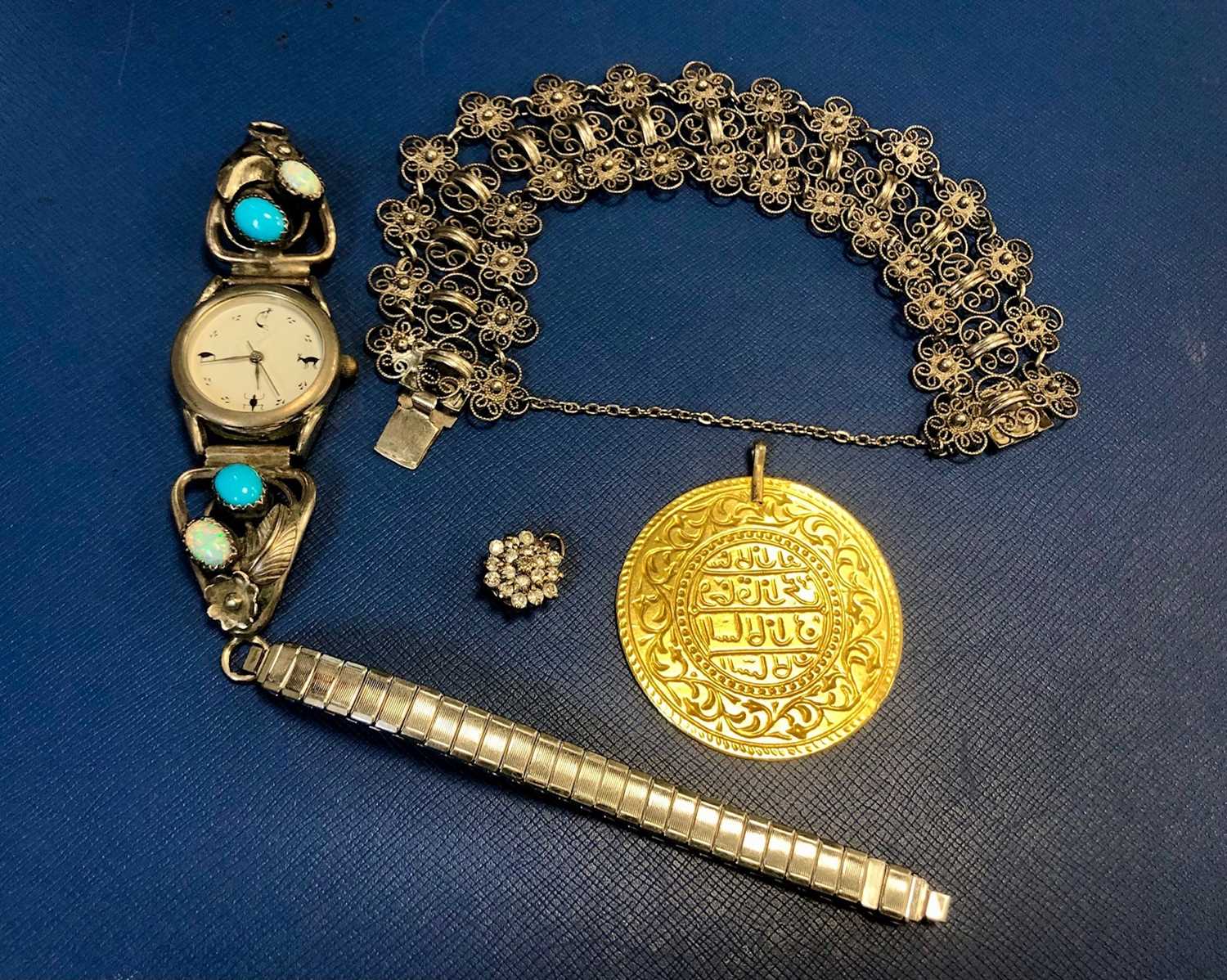 Lot 20 - A SILVER FILIGREE BRACELET, SILVER AND STONE SET WRIST WATCH, A MEDALLION AND A STONE SET CLUSTER PENDANT