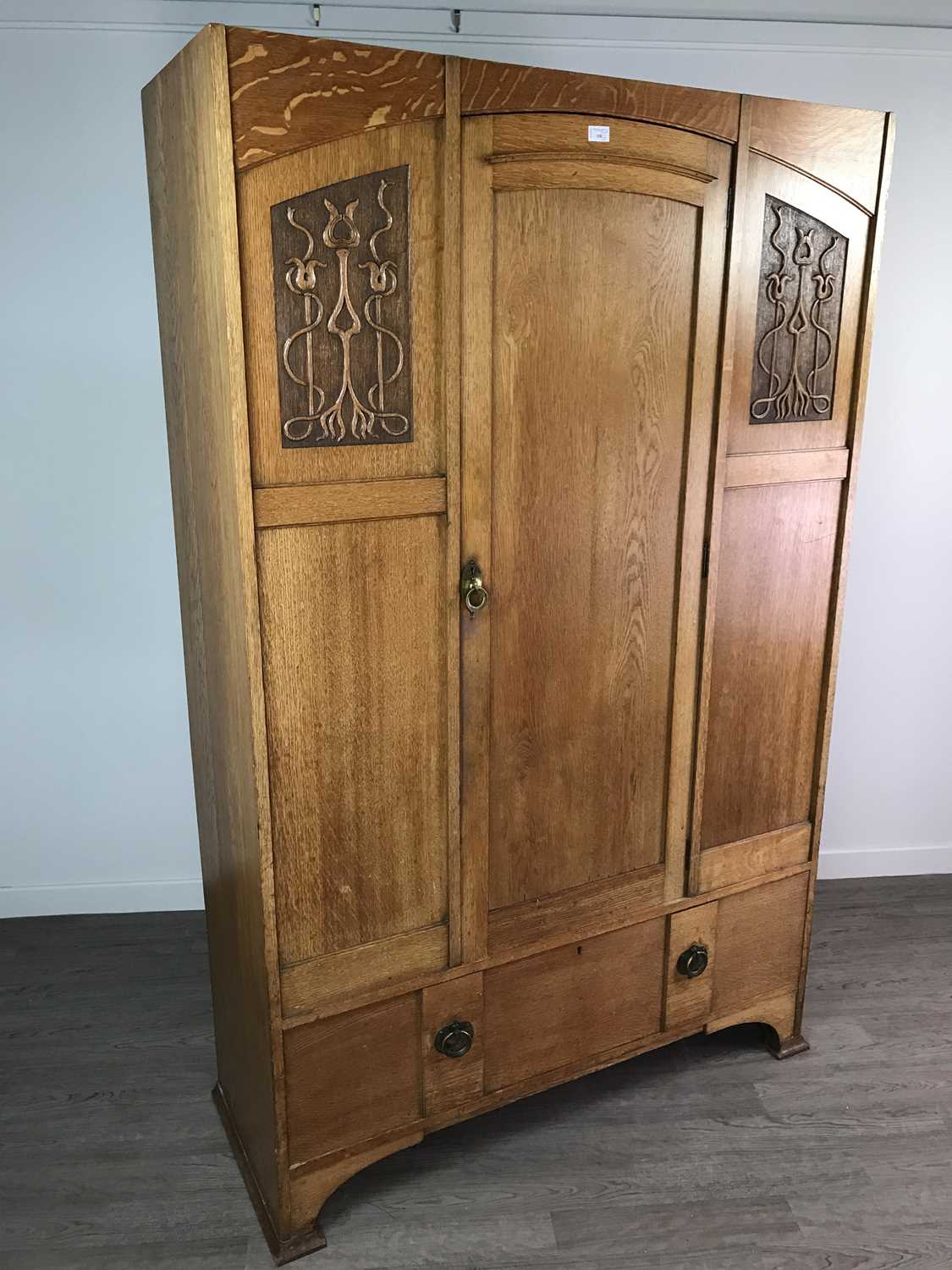 Lot 150 - AN ARTS & CRAFTS OAK WARDROBE AND A CHEST OF DRAWERS