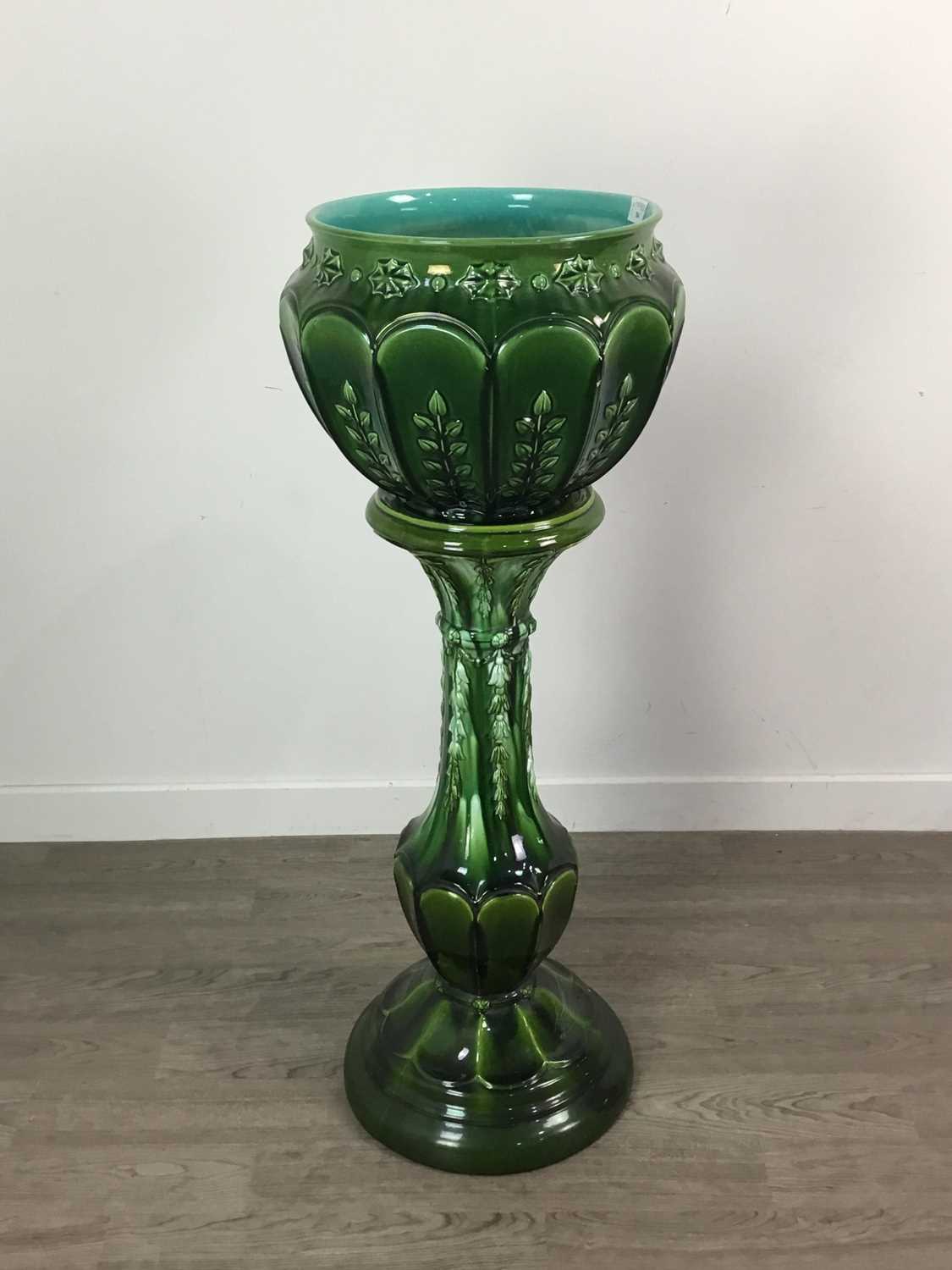 Lot 704 - A 19TH CENTURY GREEN GLAZED MAJOLICA JARDINIERE ON STAND
