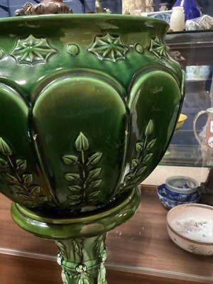 Lot 704 - A 19TH CENTURY GREEN GLAZED MAJOLICA JARDINIERE ON STAND