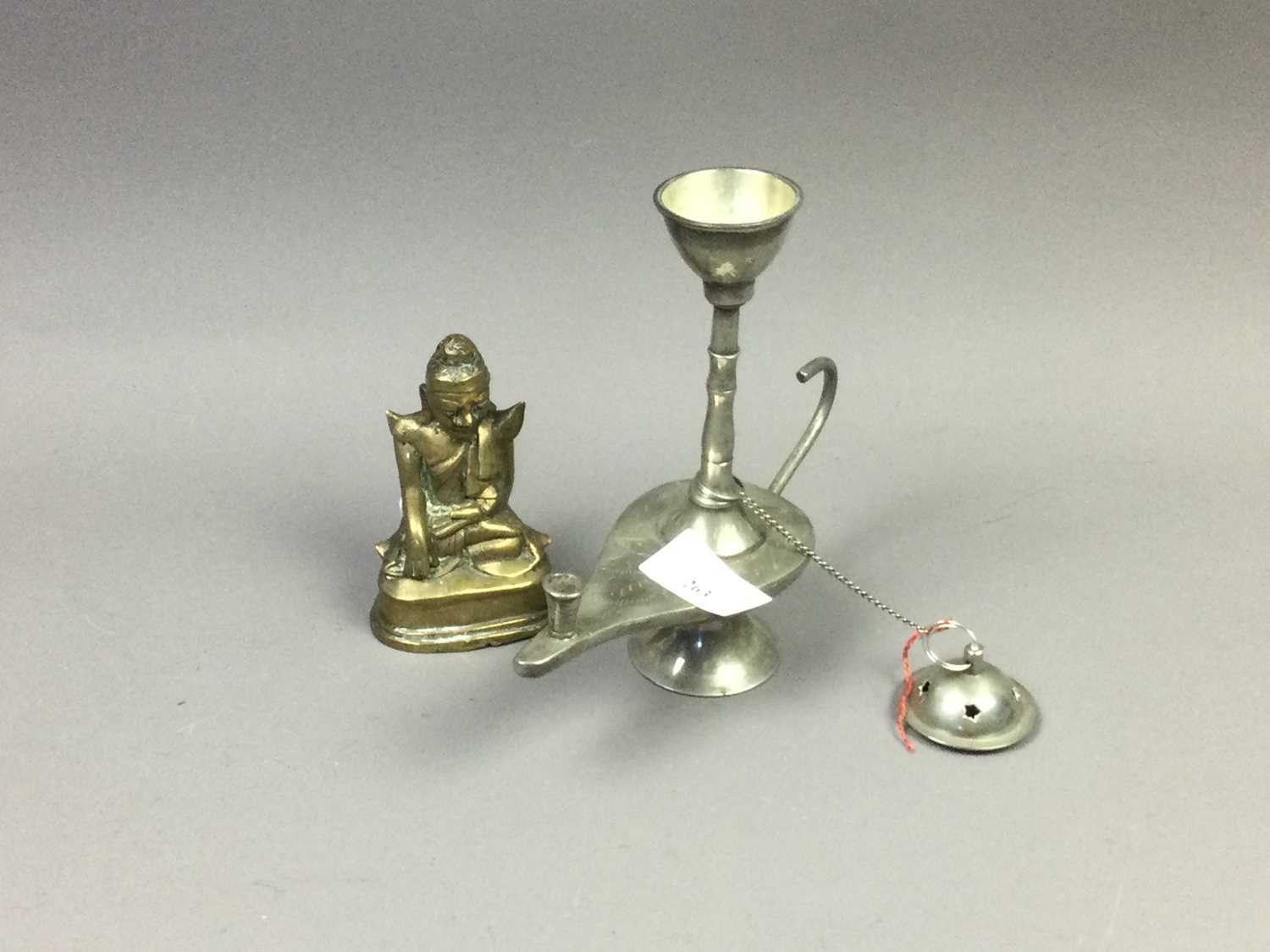 Lot 263 - AN EASTERN WHITE METAL LAMP AND A BRONZE FIGURE