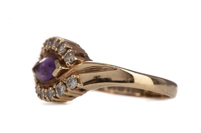Lot 858 - AN AMETHYST AND WHITE GEM SET RING
