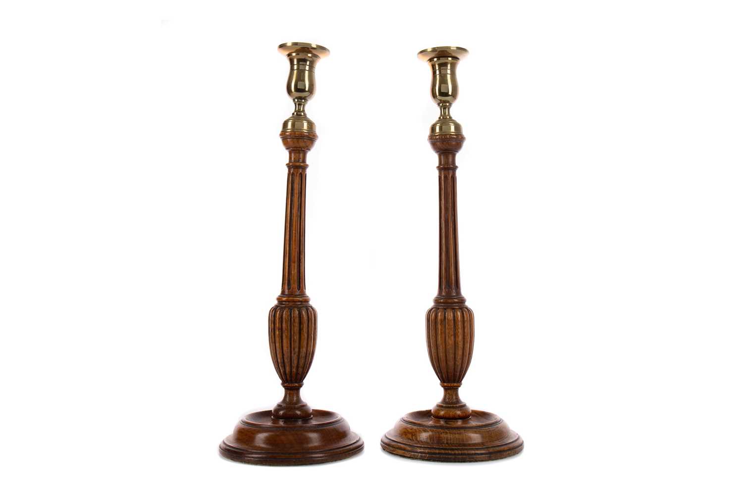 Lot 1348 - A PAIR OF GEORGE III STYLE OAK CANDLESTICKS