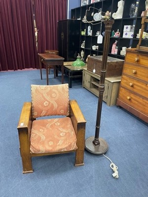Lot 526 - A FIRESIDE ARMCHAIR AND A STANDARD LAMP WITH SHADE
