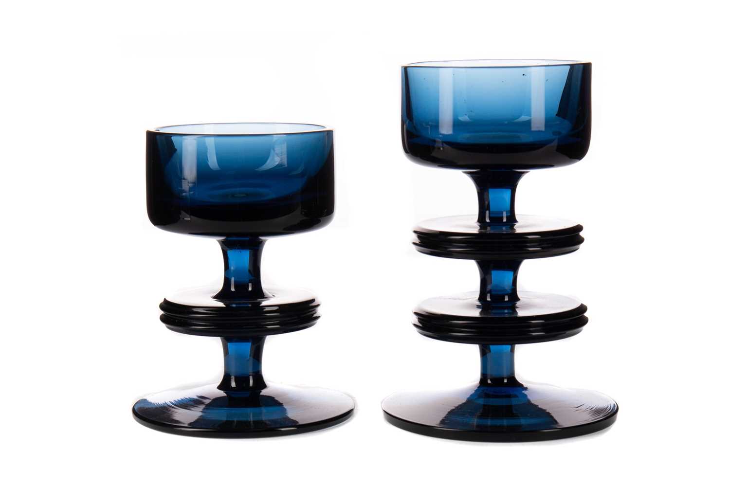 Lot 714 - TWO BLUE GLASS CANDLESTICK BY RONALD STENNETT WILSON FOR WEDGWOOD