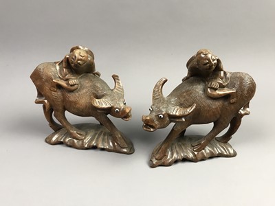 Lot 638 - A PAIR OF EARLY 20TH CENTURY CHINESE CARVED WATER BUFFALOS AND RIDERS
