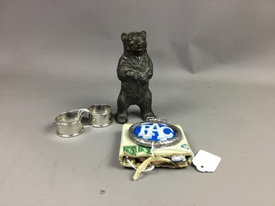 Lot 195 - A BEAR MONEY BANK, SILVER NAPKIN RINGS AND CAR BADGES