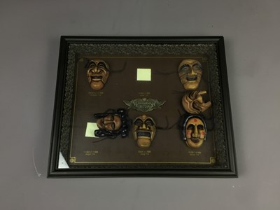 Lot 265 - A FRAMED CASE WITH SIX MINIATURE KOREAN MASKS