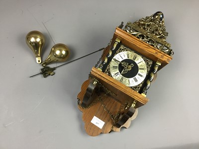 Lot 457 - A REPRODUCTION BRASS AND OAK WALL CLOCK