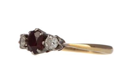 Lot 340 - A SYNTHETIC RUBY AND DIAMOND THREE STONE RING