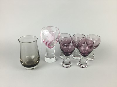 Lot 111 - A CAITHNESS AMETHYST GLASS LIQUEUR SET ALONG WITH ANOTHER