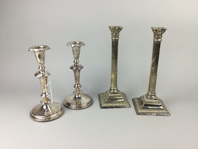 Lot 299 - A PAIR OF SILVER PLATED CORINTHIAN COLUMN CANDLESTICKS ALONG WITH ANOTHER PAIR OF CANDLESTICKS