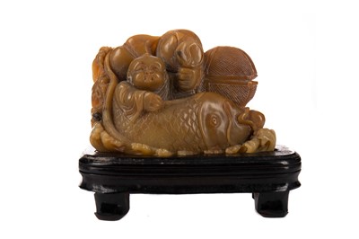 Lot 1775 - A CHINESE SOAPSTONE BOY AND FISH CARVING