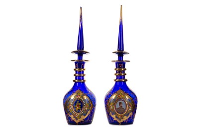 Lot 1818 - A PAIR OF PERSIAN GLASS DECANTERS AND STOPPERS