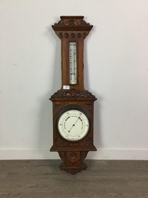 Lot 600 - A LATE VICTORIAN OAK CASED ANEROID BAROMETER AND THERMOMETER