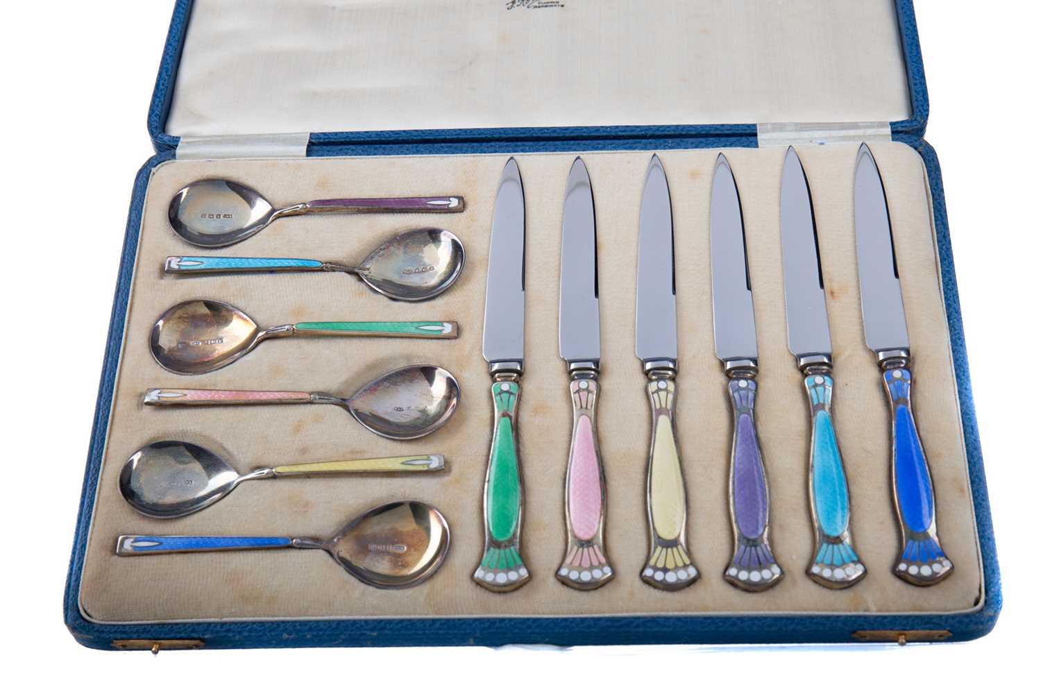 Lot 541 - A CASED SET OF GEORGE V SILVER AND GUILLOCHE ENAMEL DESSERT SPOONS AND KNIVES