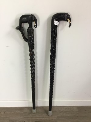 Lot 417 - A LOT OF TWO EBONISED WALKING CANES