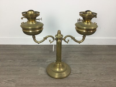 Lot 523 - A BRASS DOUBLE OIL LAMP