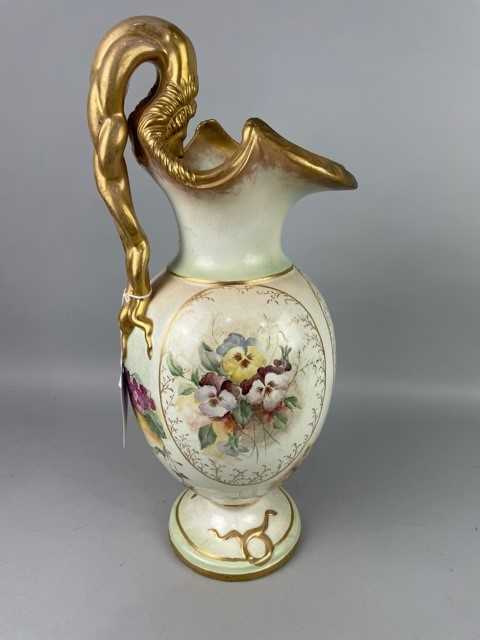 Lot 125 - A LARGE CERAMIC FLORAL DECORATED EWER