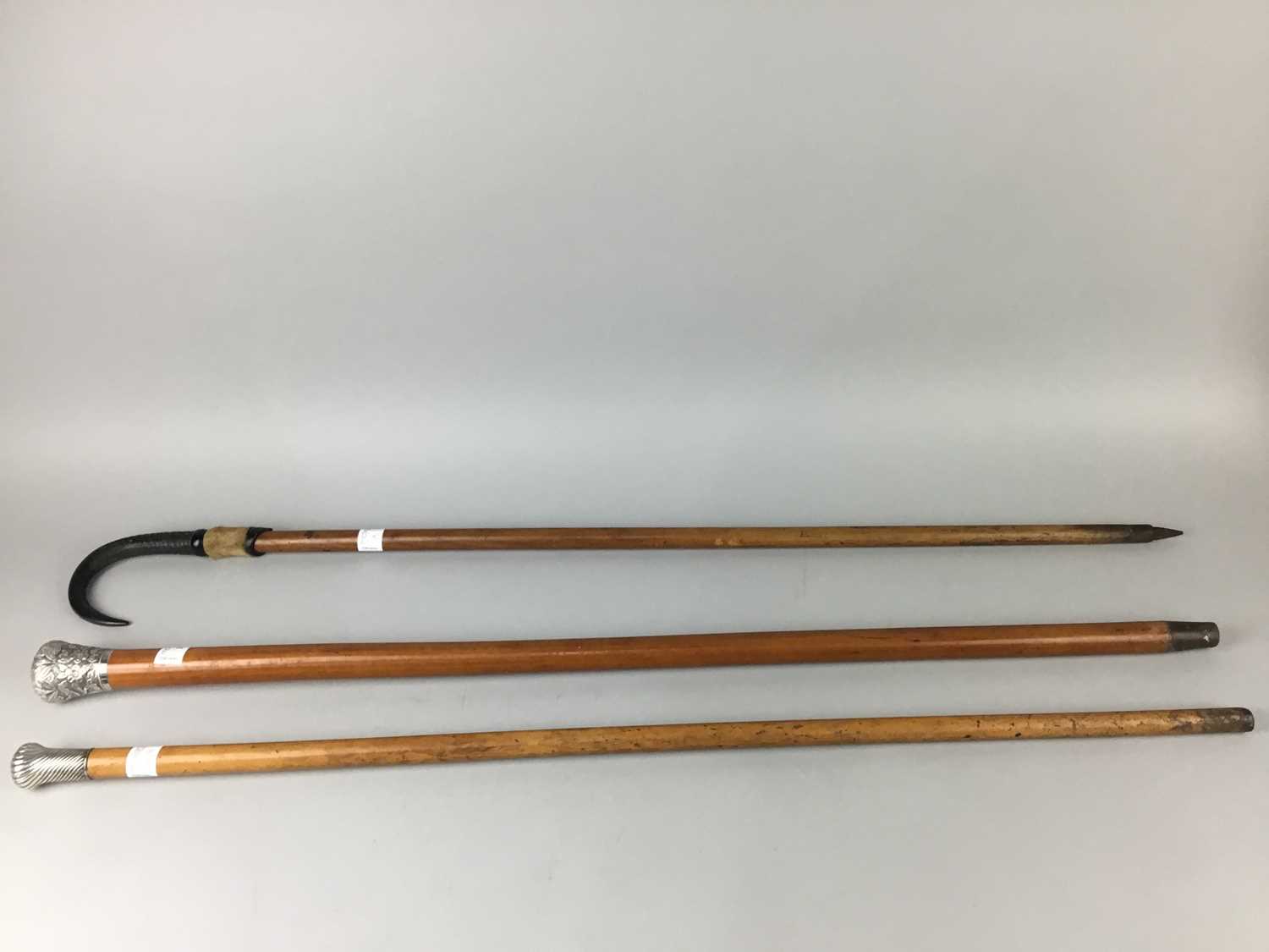 Lot 29 - A VICTORIAN MALACCA WALKING CANE AND OTHERS