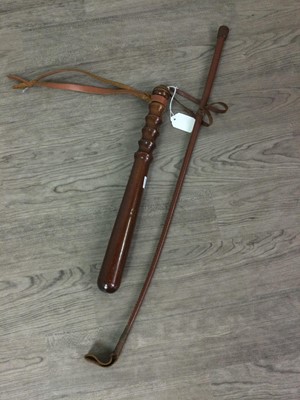 Lot 382 - A TURNED WOODEN TRUNCHEON AND A LEATHER RIDING CROP