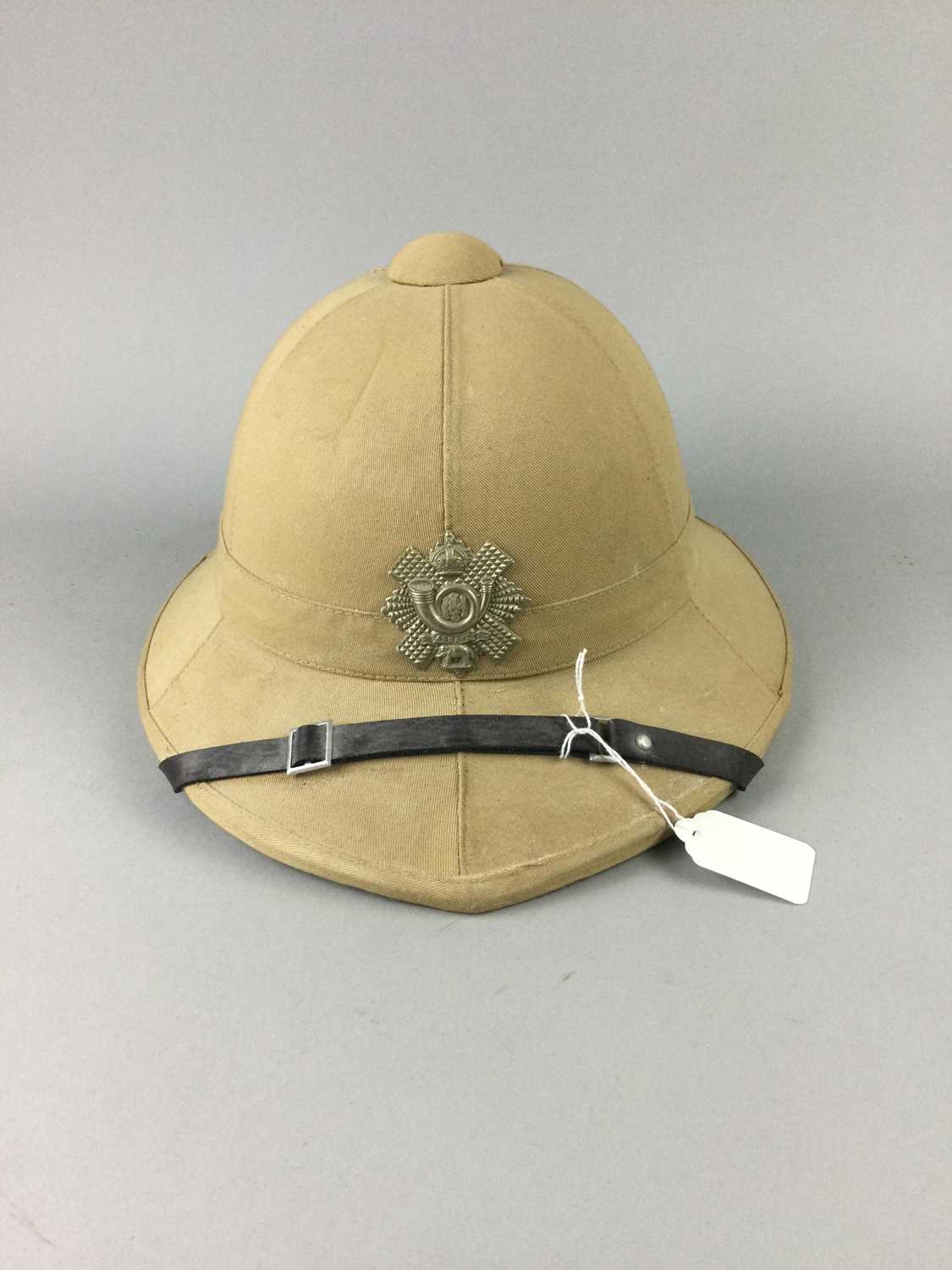 Lot 328 - A PITH HELMET WITH HLI BADGE
