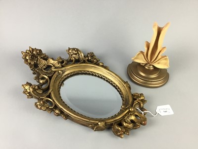 Lot 545 - A GILT OVAL WALL MIRROR AND A WALL MOUNTING SCONCE