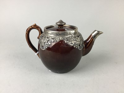 Lot 563 - A SILVER MOUNTED TEAPOT