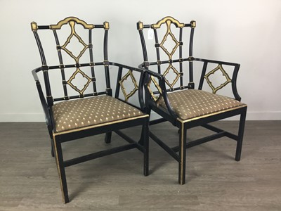 Lot 832 - A PAIR OF EBONISED OPEN ELBOW CHAIRS