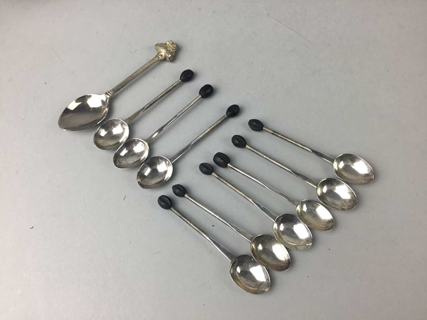 Lot 25 - A SET OF NINE SILVER COFFEE SPOONS AND A SOUVENIR SPOON