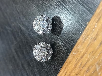 Lot 1228 - A PAIR OF DIAMOND CLUSTER EARRINGS