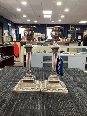 Lot 100 - A PAIR OF EDWARDIAN SILVER CANDLESTICKS