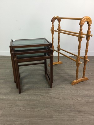 Lot 328 - A PINE TOWEL RAIL AND A NEST OF THREE GLASS TOPPED TABLES