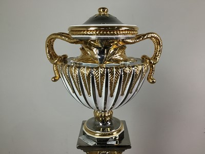 Lot 425 - AN ITALIAN SILVER LEAF AND GILT POTTERY AMPHORA SHAPED URN ON STAND