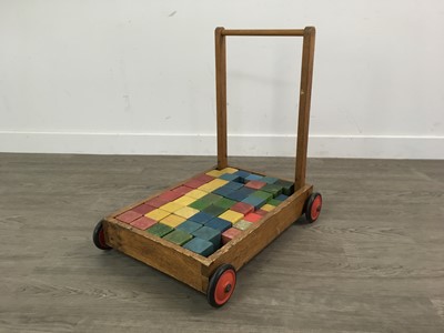 Lot 257 - A VINTAGE PUSH ALONG TROLLEY WITH BUILDING BLOCKS, TOWEL RAIL AND CHAIR