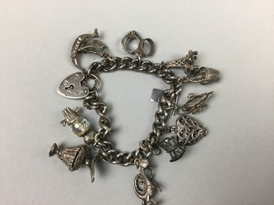 Lot 154 - A SILVER CHARM BRACELET AND MEDALS
