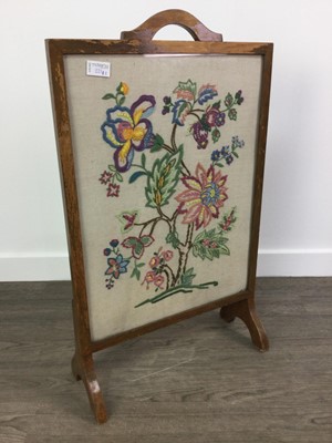 Lot 221 - A FIRESCREEN AND A WALL MIRROR