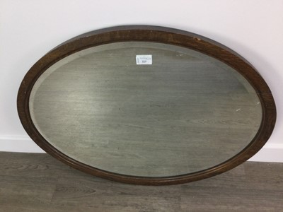 Lot 223 - AN OVAL BEVELLED WALL MIRROR