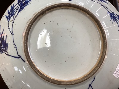 Lot 1143 - A CHINESE BLUE AND WHITE STONEWARE CIRCULAR PLAQUE