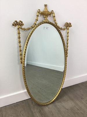 Lot 370 - AN ORNATE GILT FRAMED OVAL WALL MIRROR AND ANOTHER