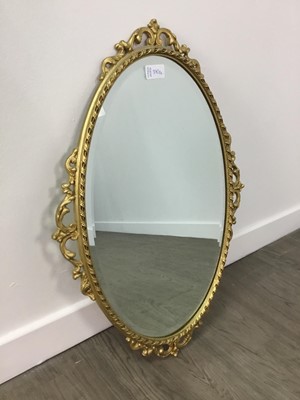 Lot 370 - AN ORNATE GILT FRAMED OVAL WALL MIRROR AND ANOTHER