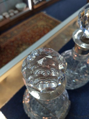 Lot 186 - A PAIR OF GEORGE V SILVER MOUNTED CLEAR GLASS DECANTERS