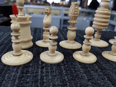 Lot 1026 - A 19TH CENTURY NATURAL AND STAINED IVORY CHESS SET