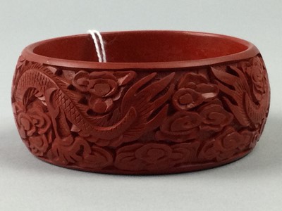 Lot 58 - A CHINESE CINNABAR LACQUER BANGLE
