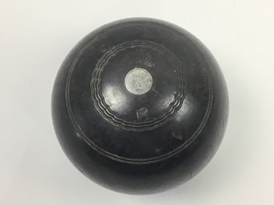 Lot 215 - A SET OF FOUR LAWN BOWLS IN A WOOD CARRY CASE