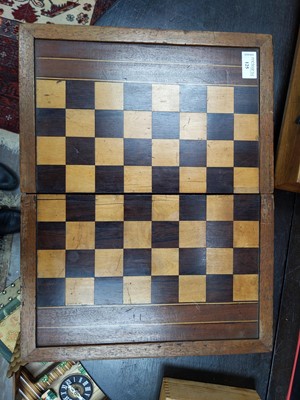 Lot 125 - A CHESS BOARD AND PIECES