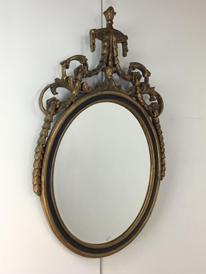 Lot 681 - A REPRODUCTION GILT AND EBONISED WALL MIRROR