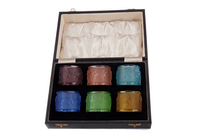 Lot 133 - A CASED SET OF COLOURED GLASS NAPKIN RINGS